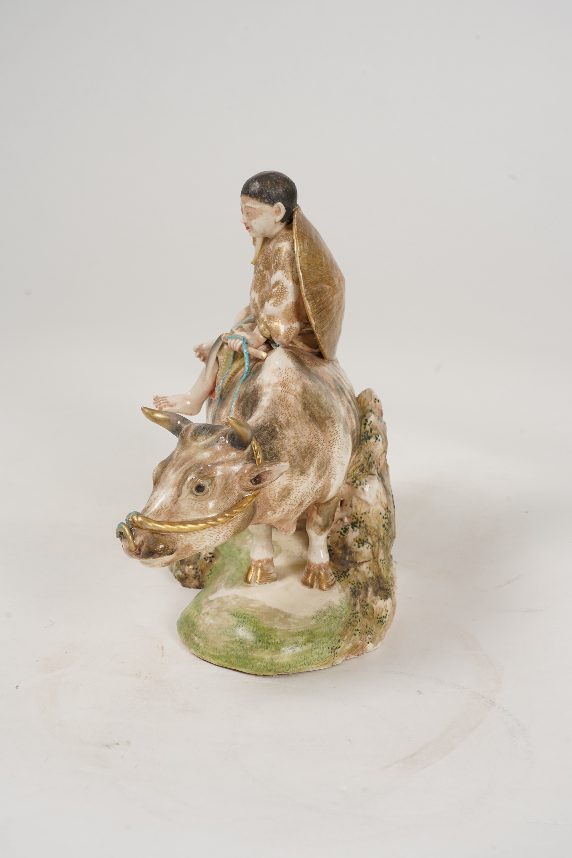 A large Japanese Satsuma model of boy riding on a buffalo, signed Hozan, Meiji period